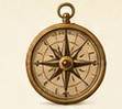 Vintage brass compass on a light background.
